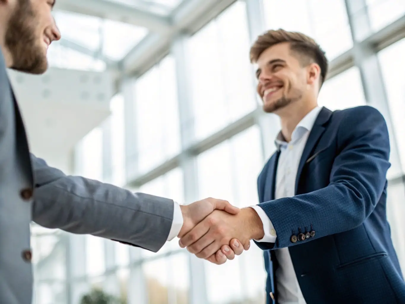 A business owner is shaking hands with an investor, representing successful funding and strategic partnerships.